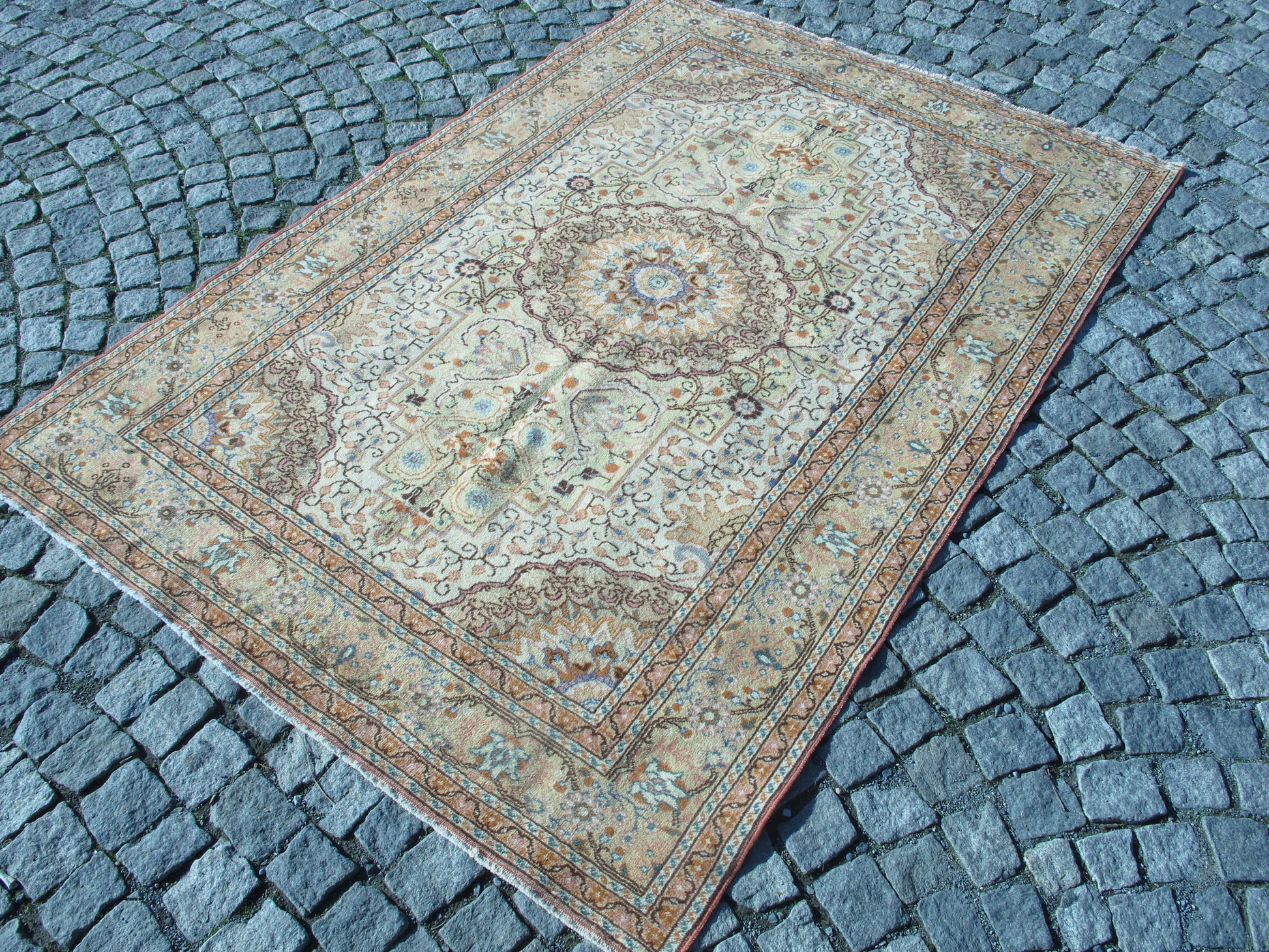 Full view of semi-antique vintage floral wool Oriental rug.
